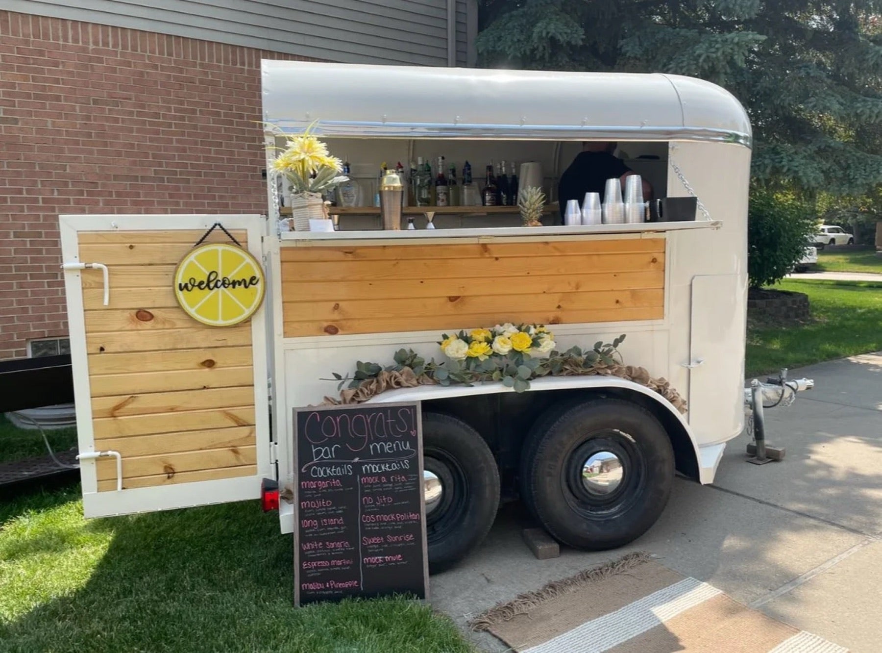 The Marmini & Co. horse-trailer mobile bar set up at an event